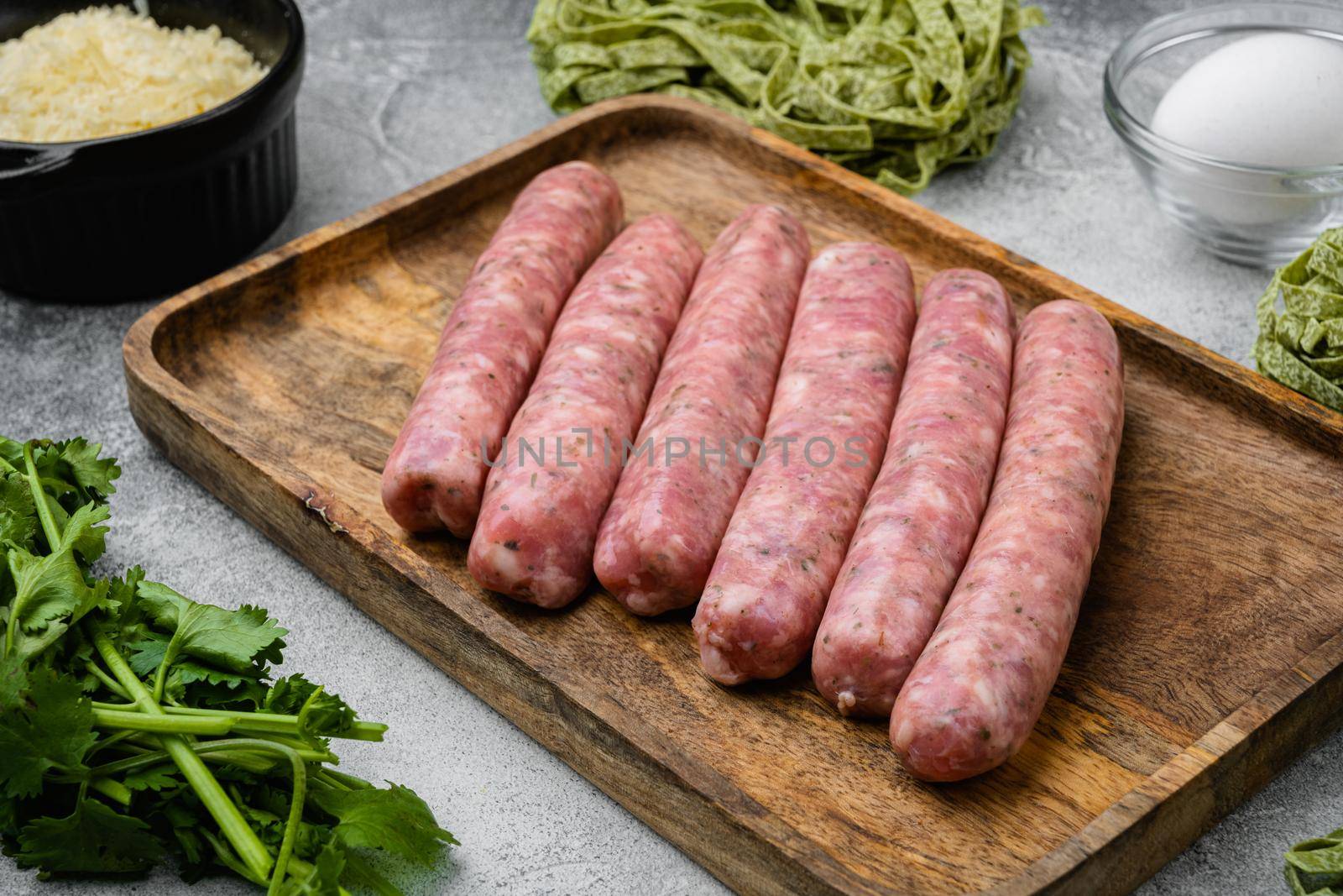 Raw Tagliatelle sausages ingredients set, on gray stone table background