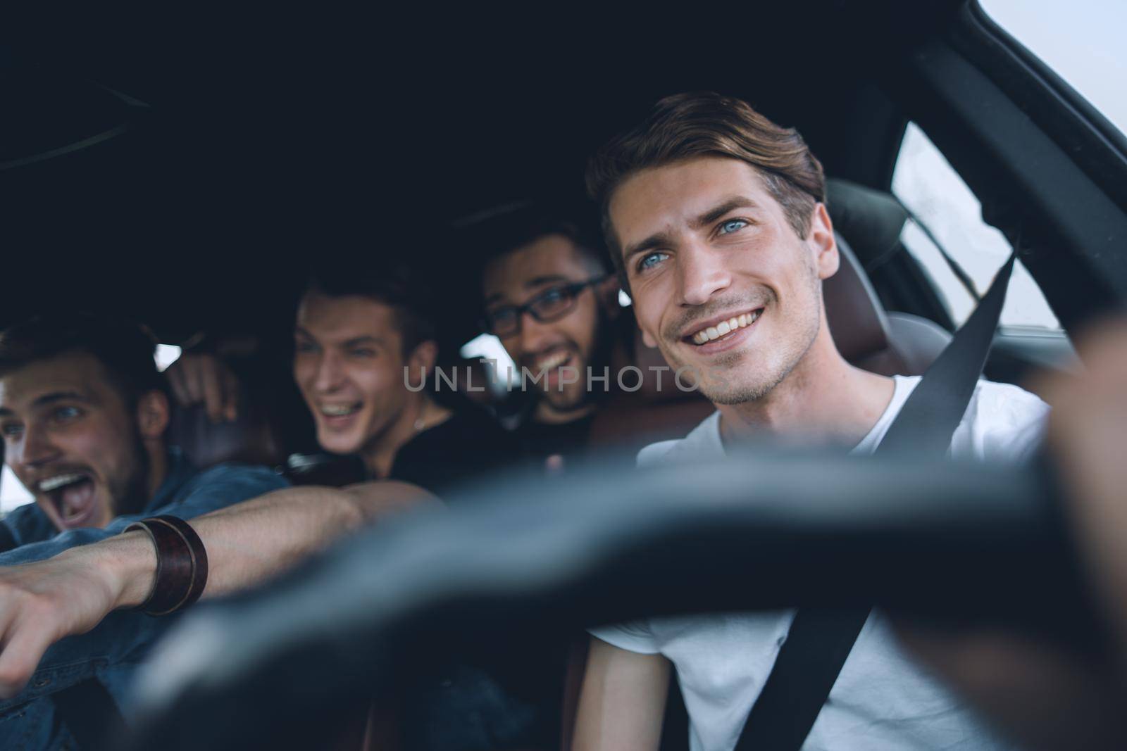 A group of people inside a car, on a road trip by asdf