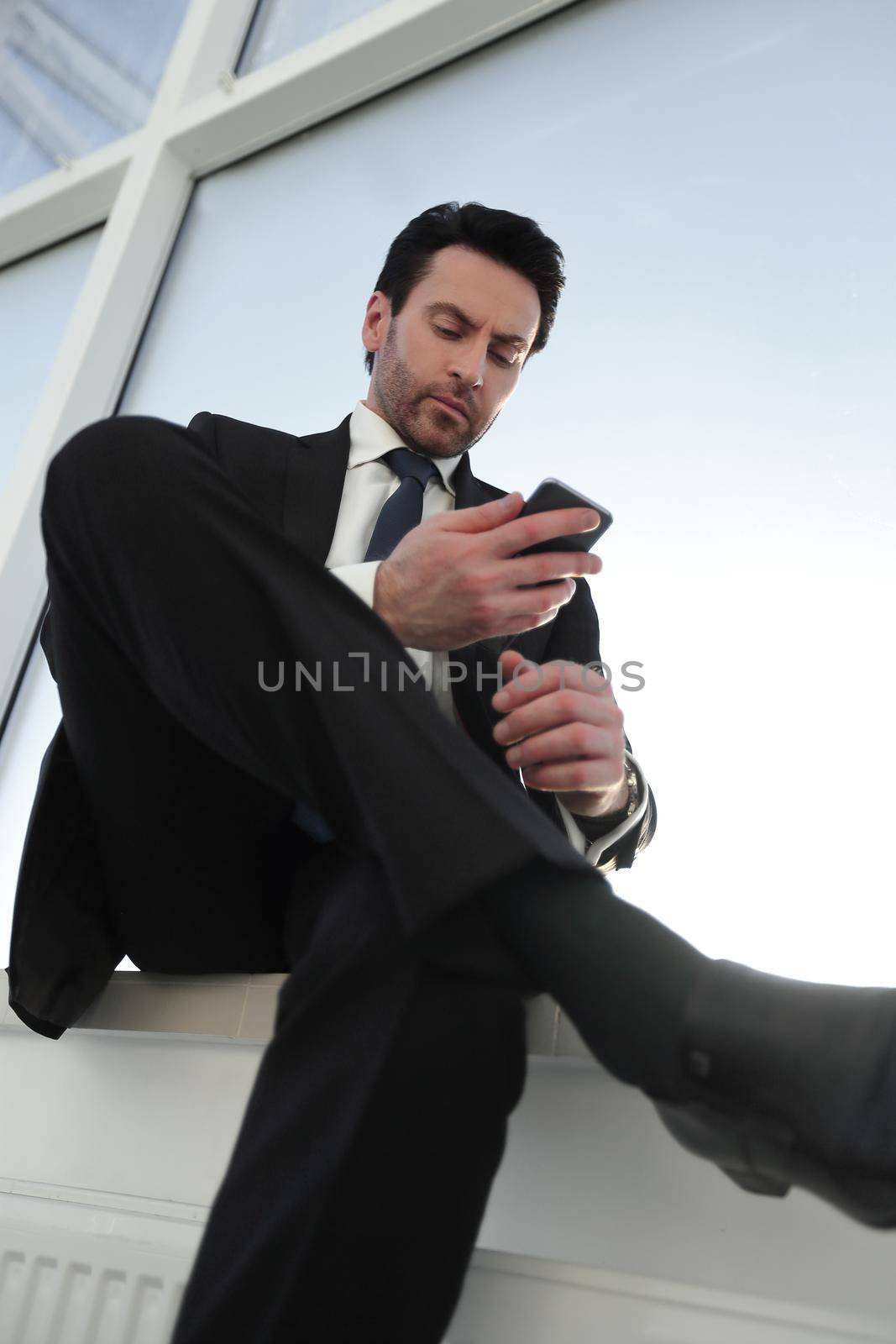 businessman typing SMS on his smartphone. business and technology
