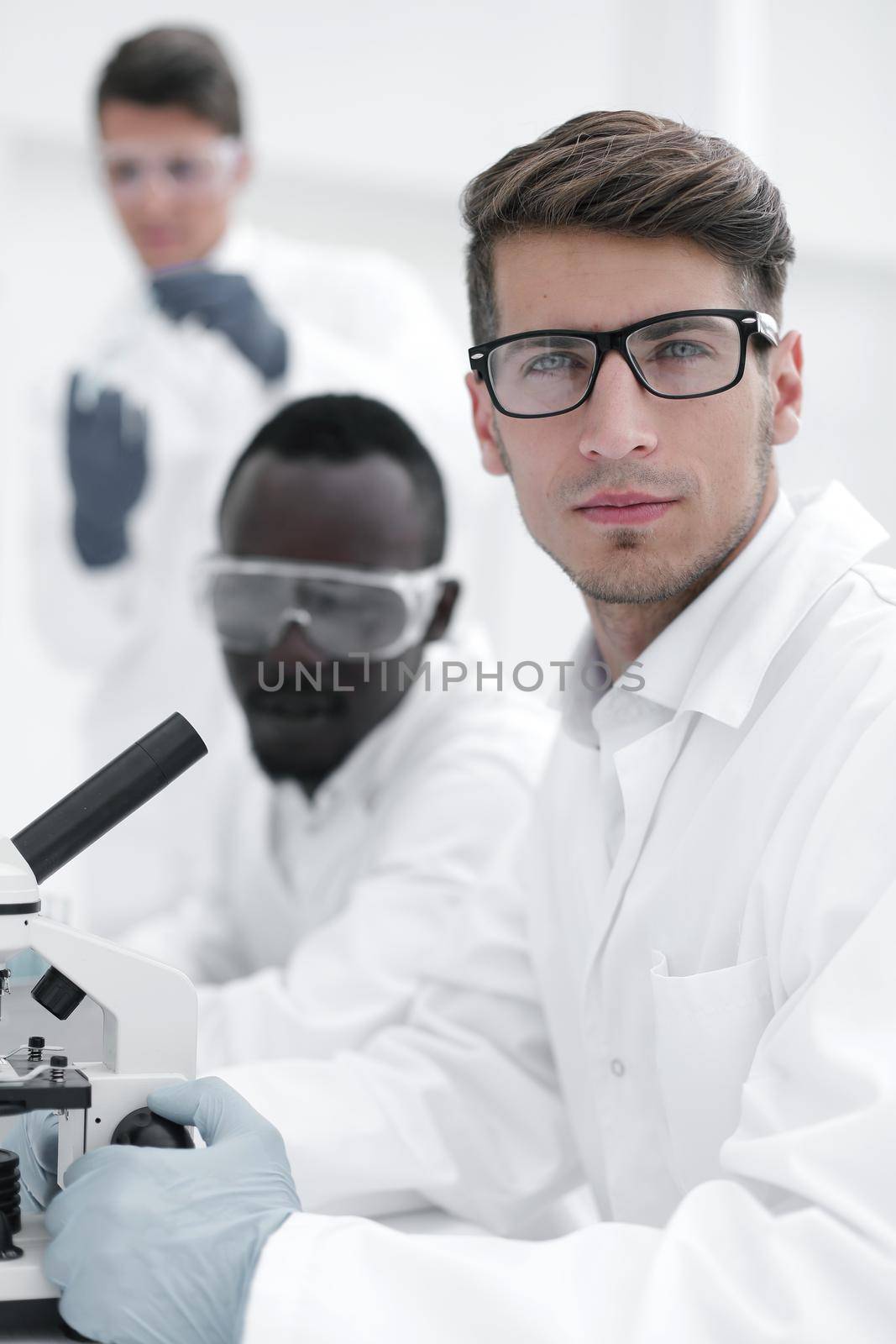 close up.serious scientist scientist sitting at the table and looking at the camera.science and technology