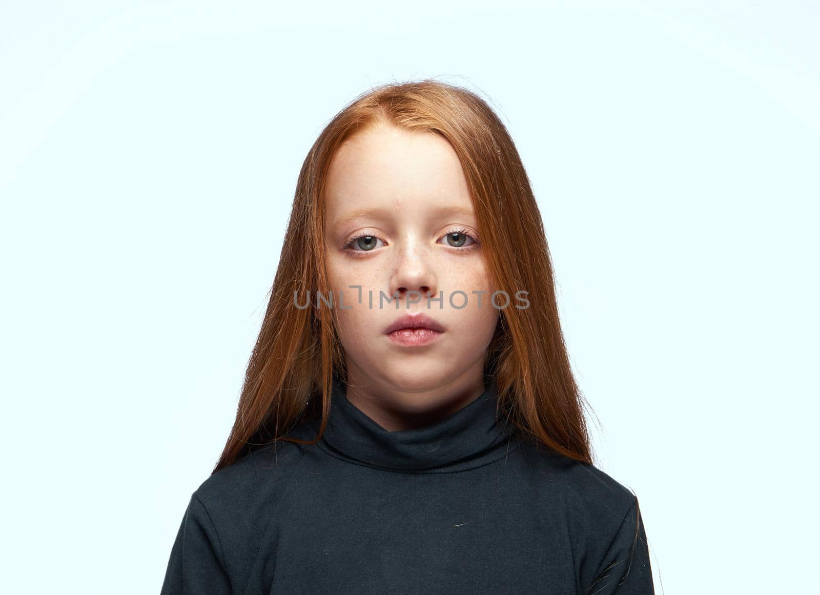 red-haired girl in a black sweater planning close-up. High quality photo
