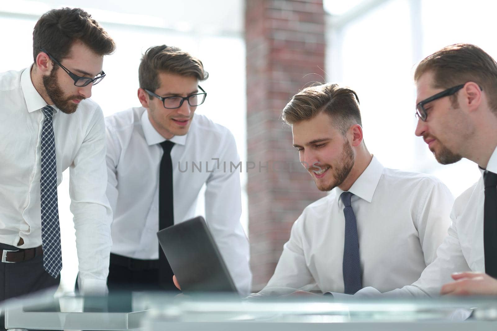 business colleagues standing near the desktop by asdf