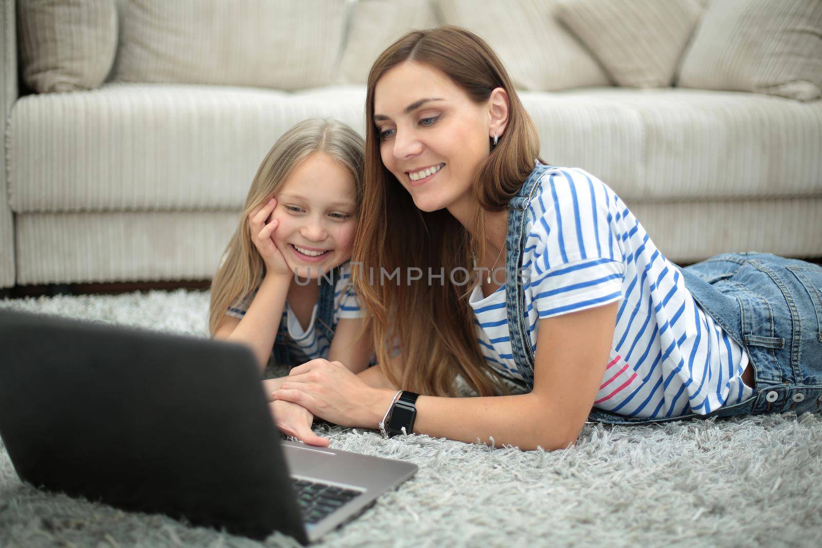 mother and daughter using a laptop in their home.people and technology