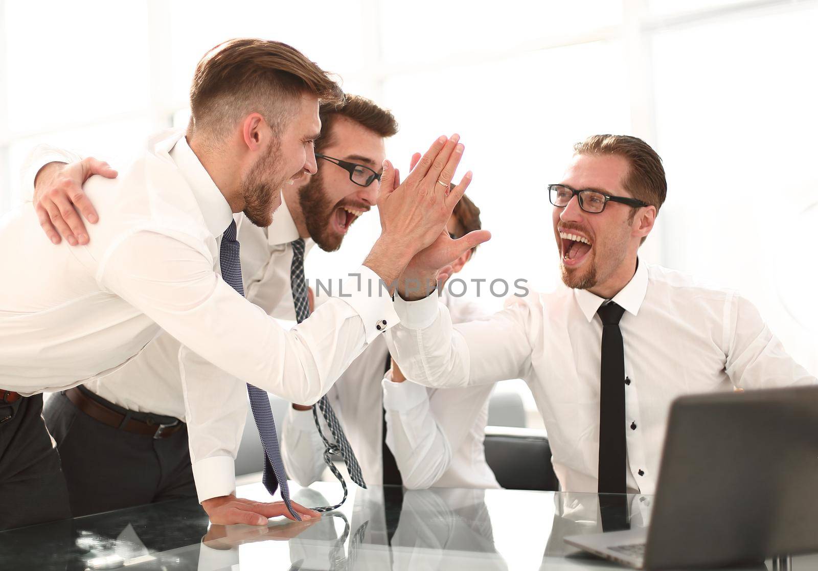 employees giving each other a high five.success concept