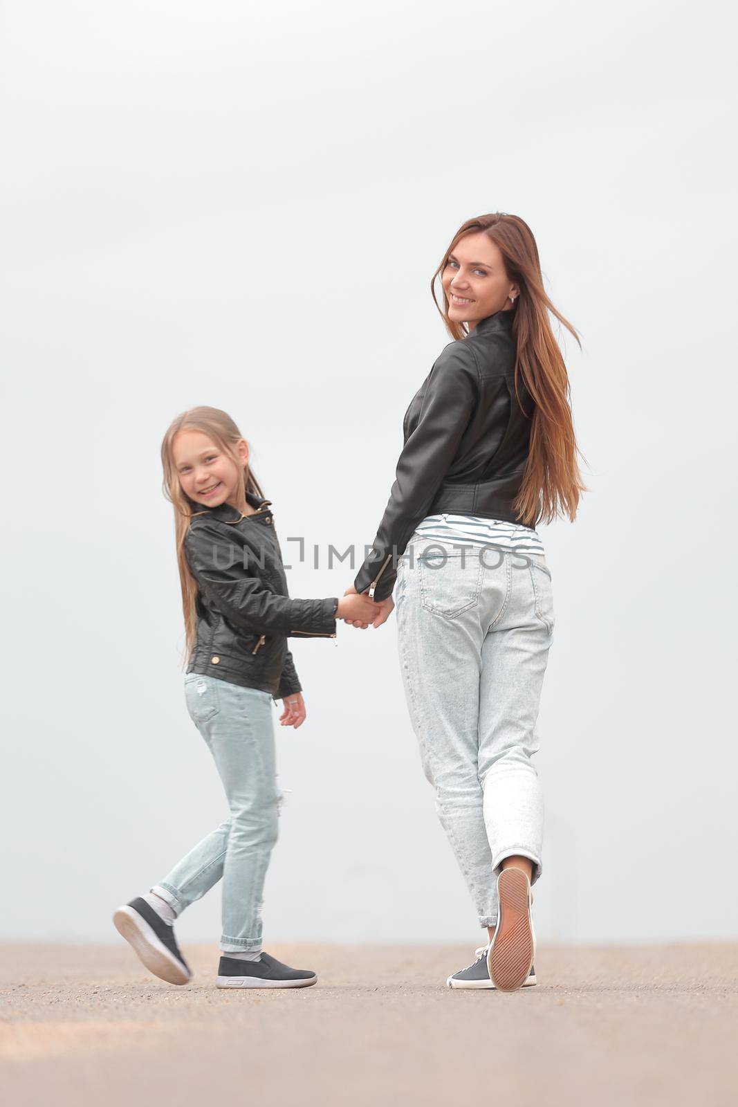 rear view. mother and daughter walk together by asdf