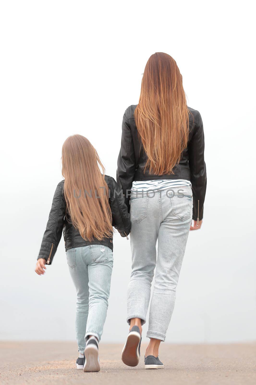 rear view. mother and daughter walk together by asdf