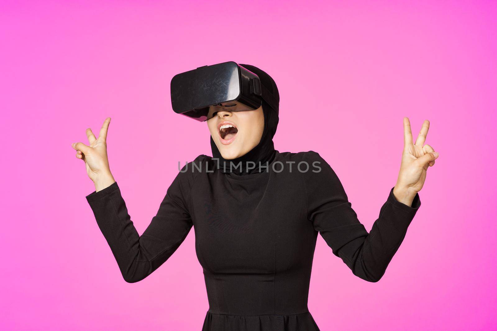 woman in black hijab glasses virtual reality technology movie watching. High quality photo