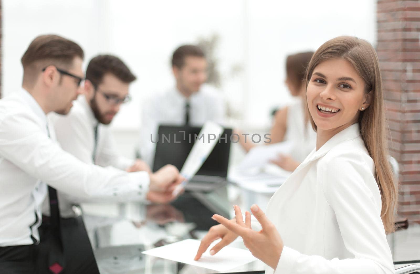 young employee sitting at his Desk and looking at the camera. the concept of teamwork