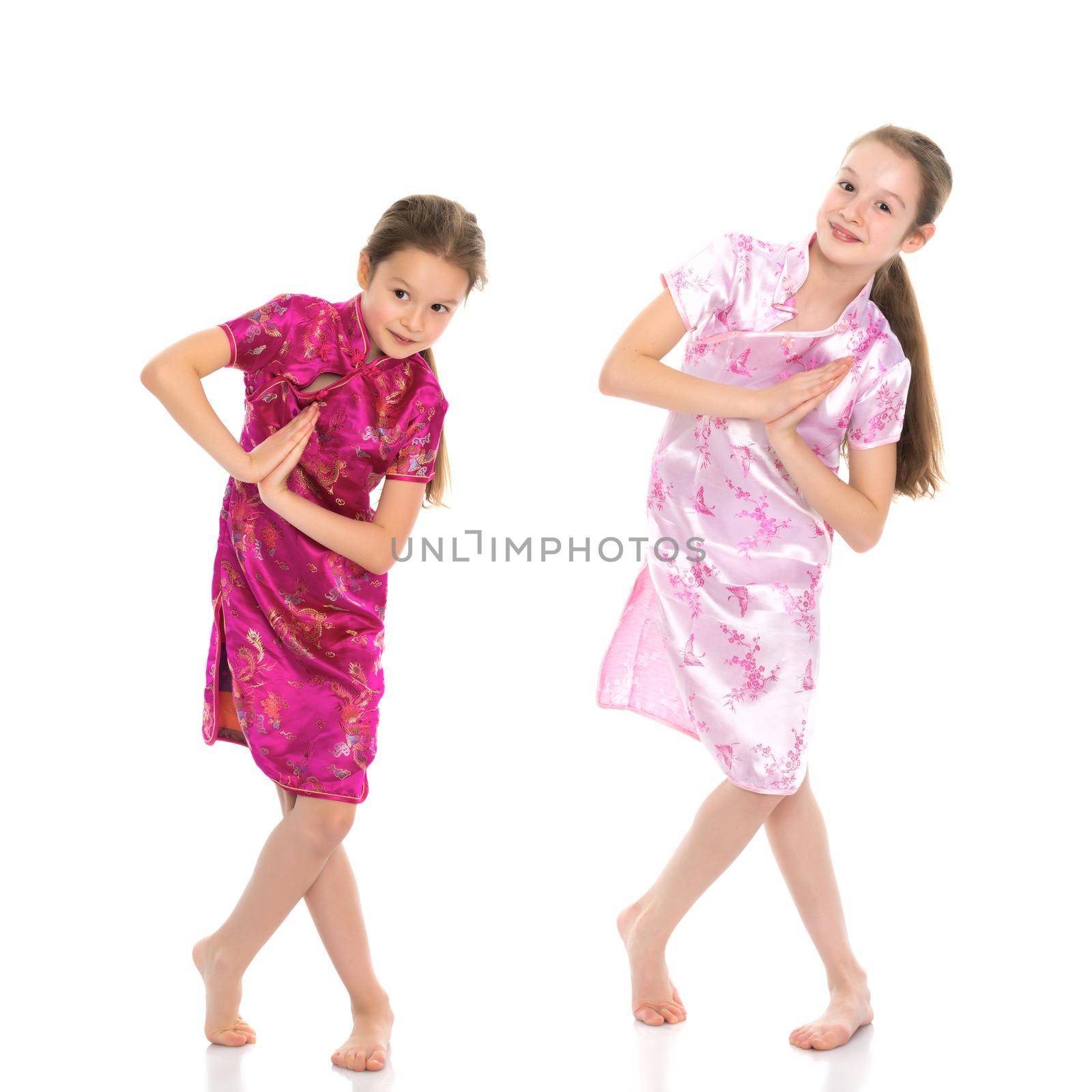 Girls are sisters in Chinese national dresses. by kolesnikov_studio