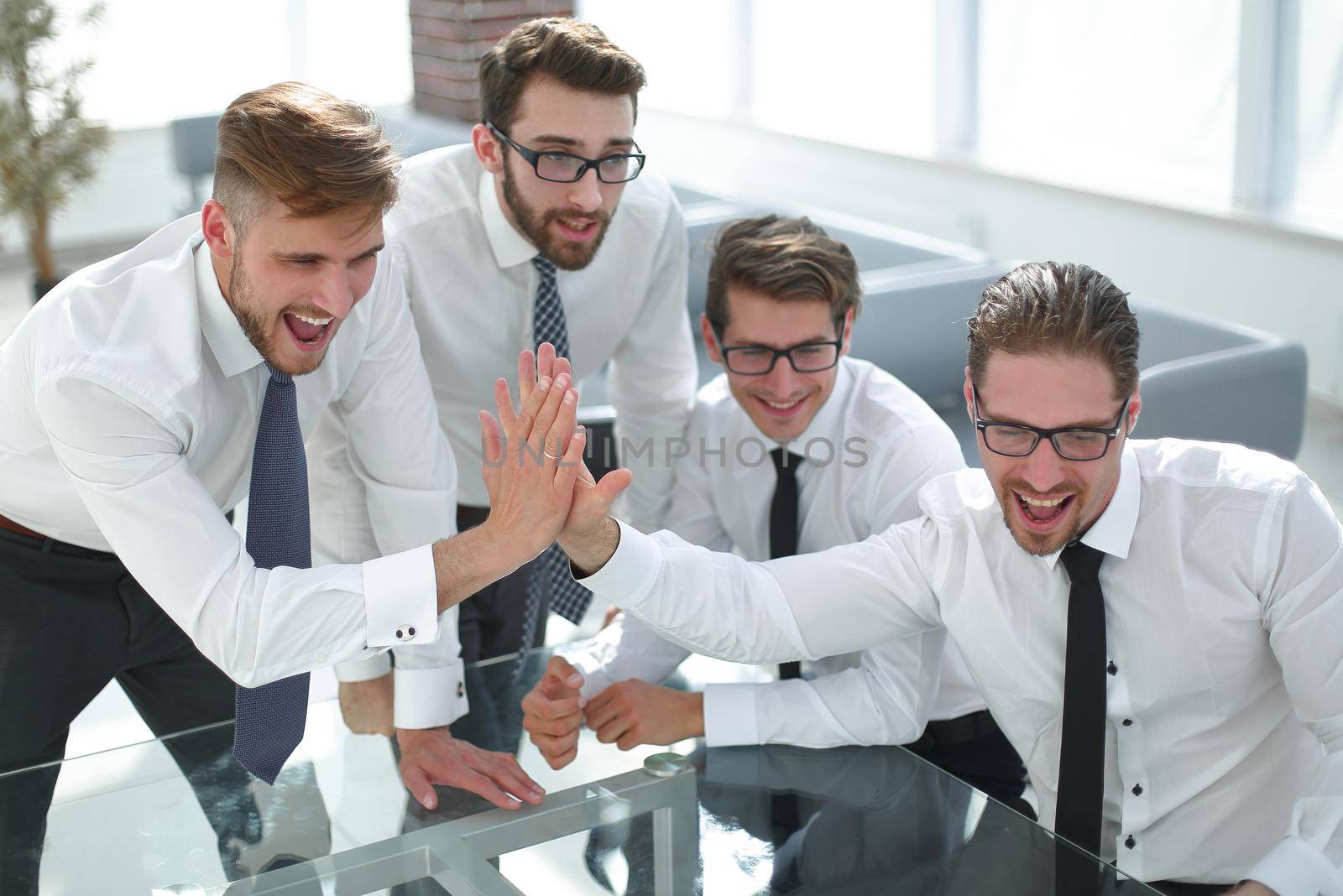 employees giving each other a high five.success concept