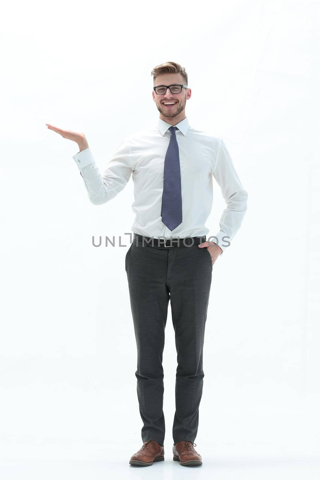 in full growth. successful businessman showing a hand with a blank space.photo with text space