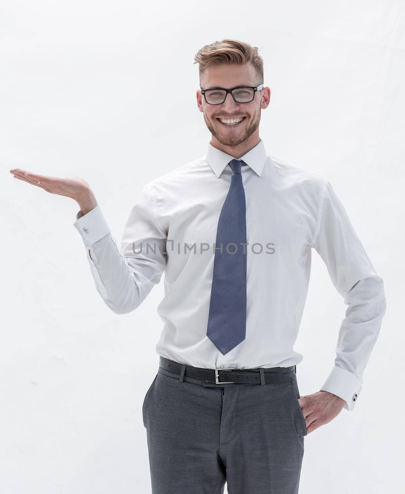 in full growth. successful businessman showing a hand with a blank space.photo with text space