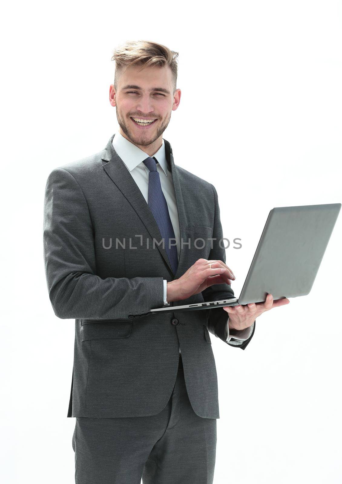 in full growth, a businessman with an open laptop.isolated on white background