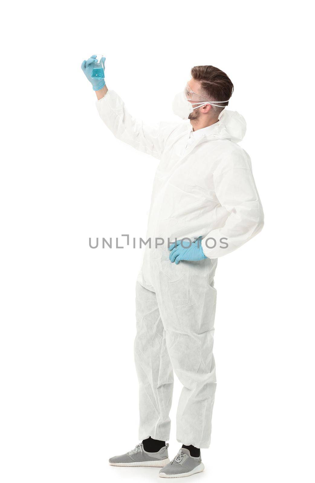 scientist looks at the blue liquid in the flask.photo with copy space