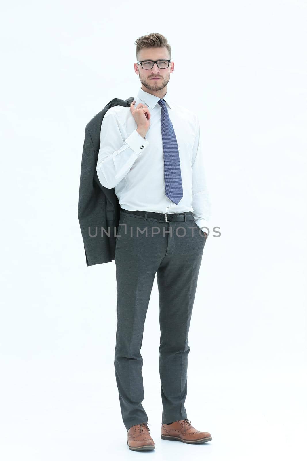 in full growth. businessman holding a jacket over his shoulder.isolated on white background