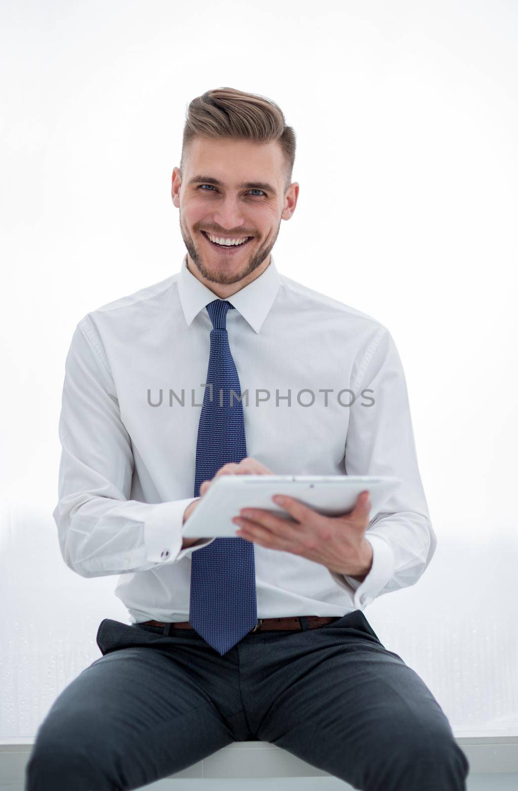 close up.smiling businessman looking at the digital tablet screen by asdf