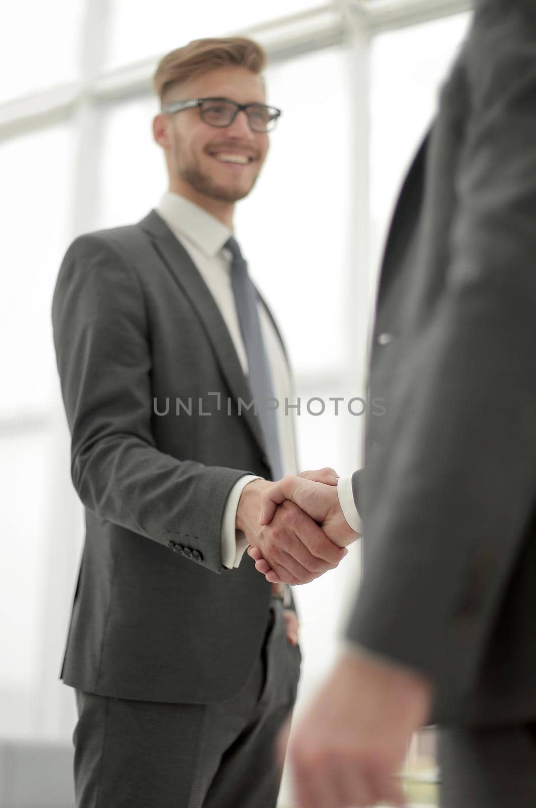 close up.strong handshake of business people.isolated on light background