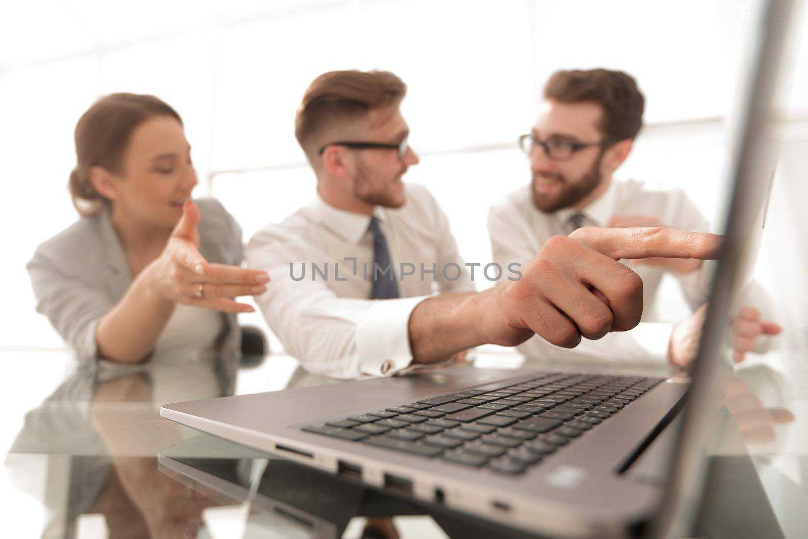close up.smiling businessman pointing at laptop screen.business and technology