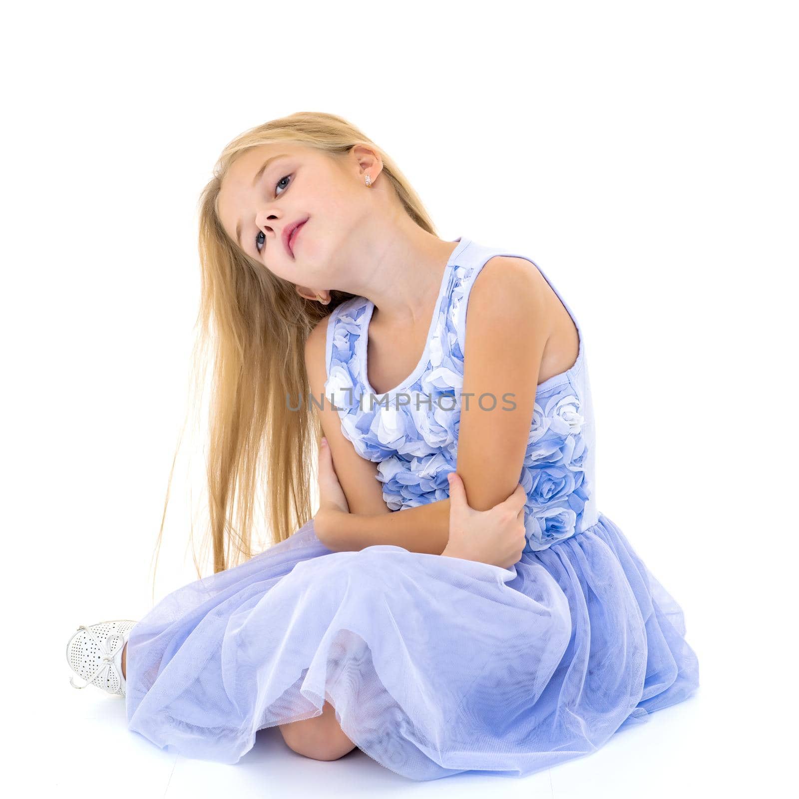 Little girl is sitting on the floor. by kolesnikov_studio