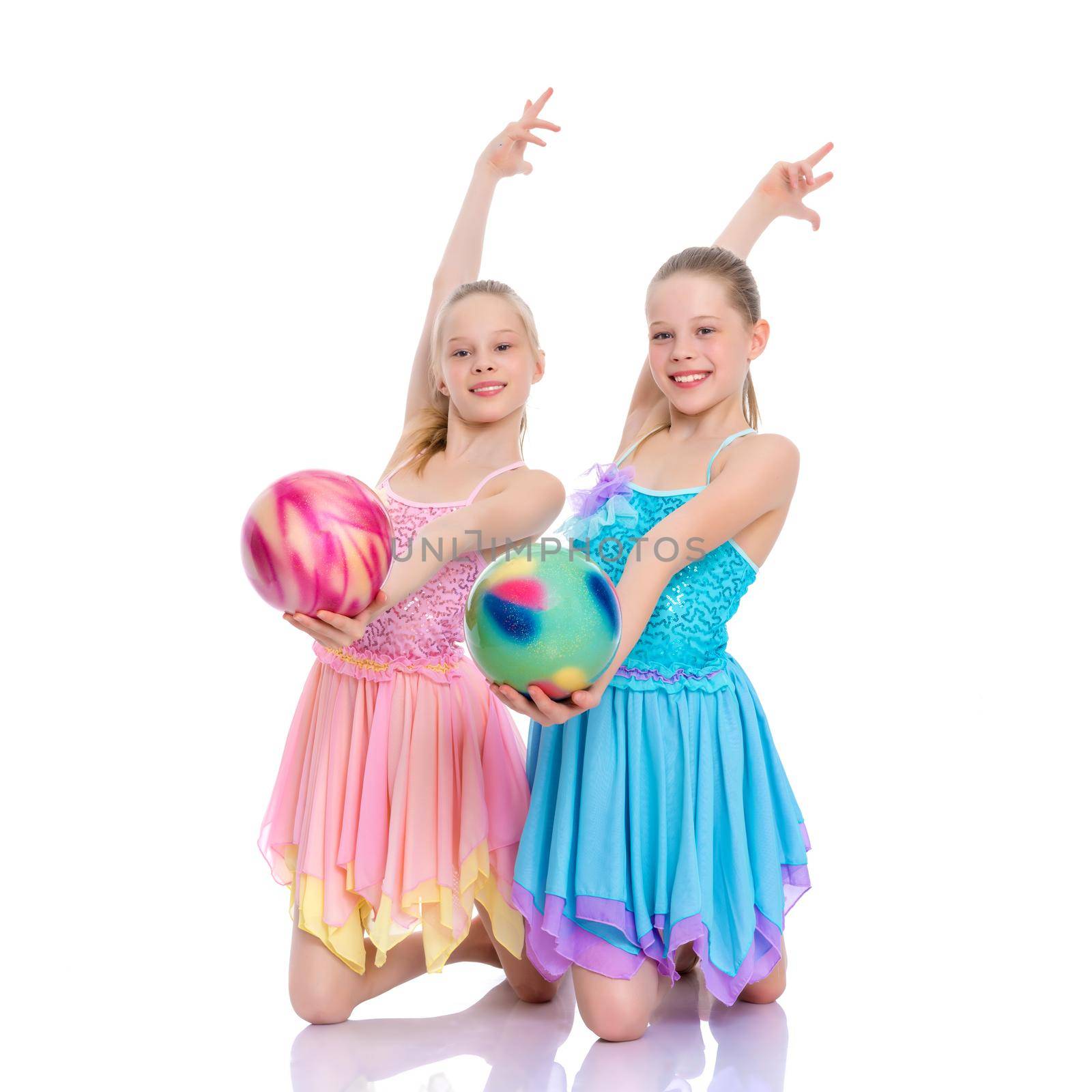 Girls gymnasts perform exercises with the ball. by kolesnikov_studio