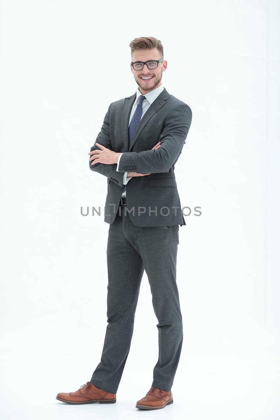 in full growth. portrait of a smiling successful businessman.isolated on white background