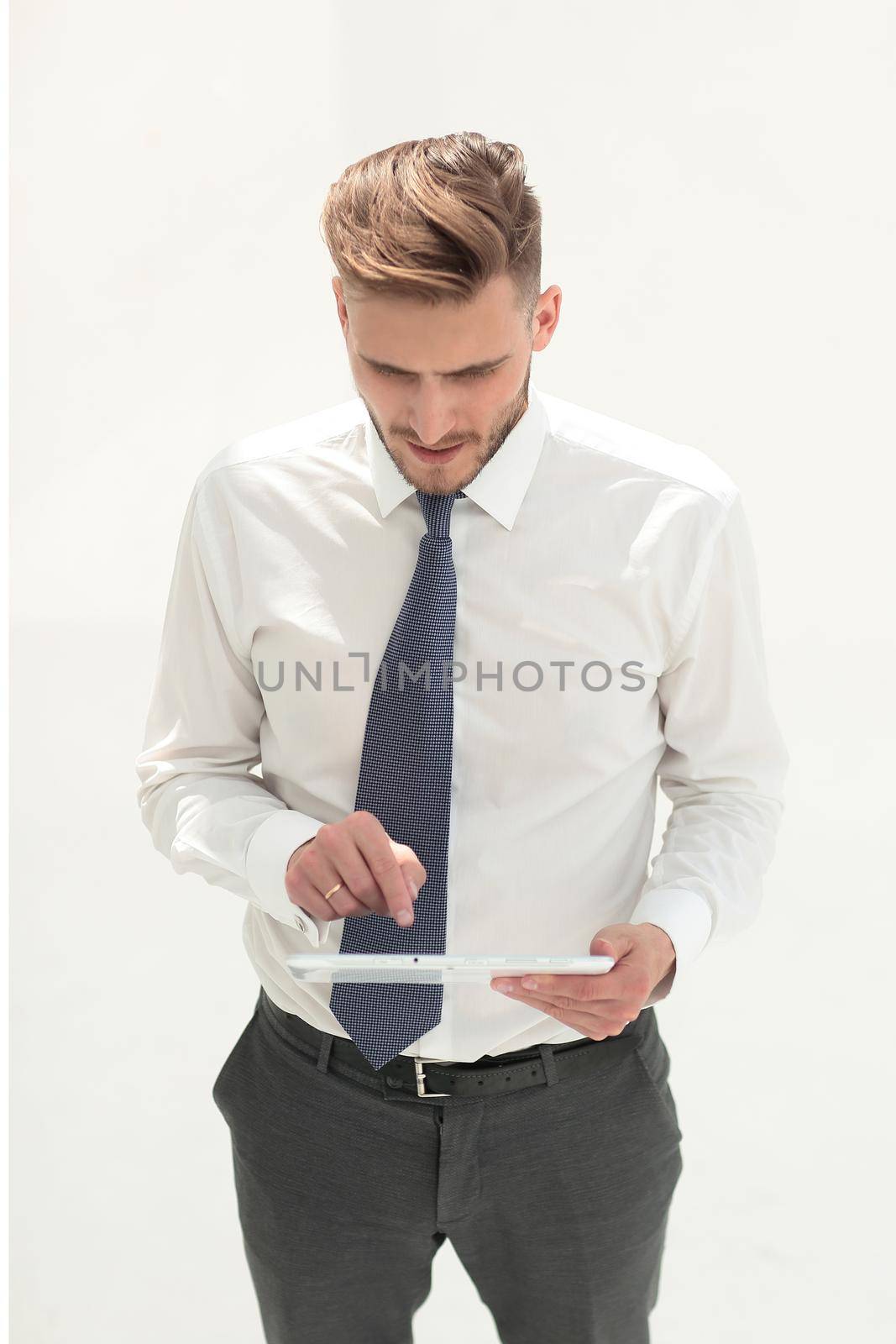 young businessman checks a new gadget by asdf