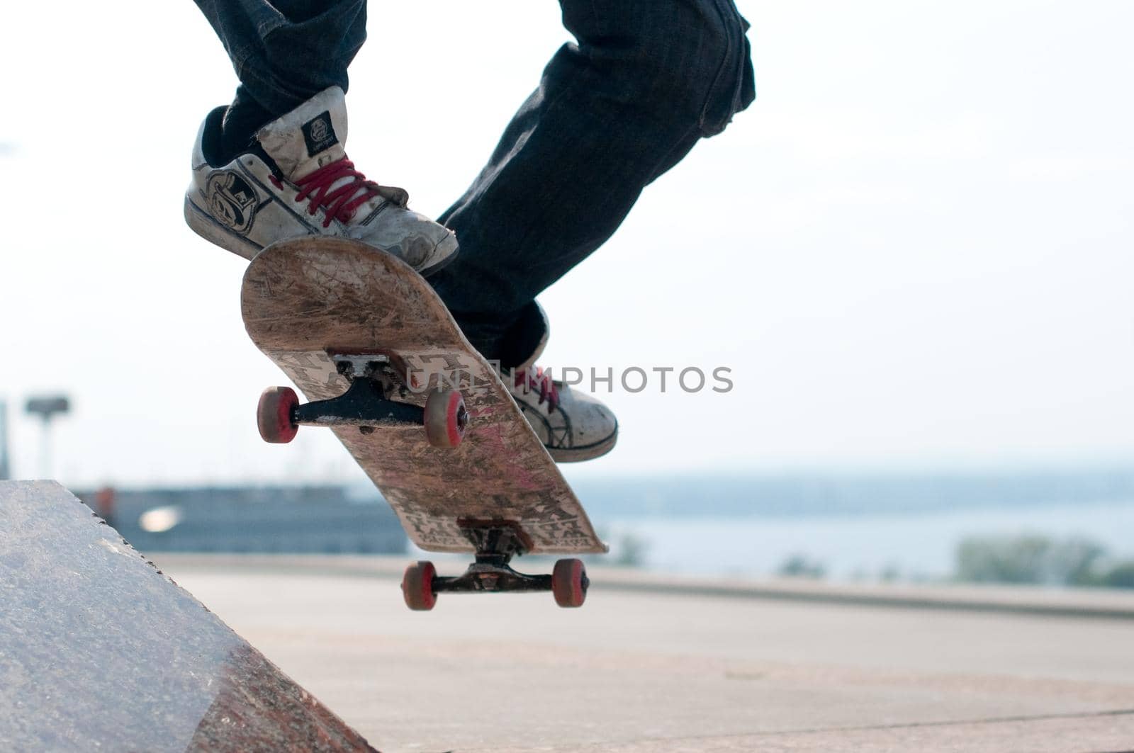 young skater performing stunt on his board