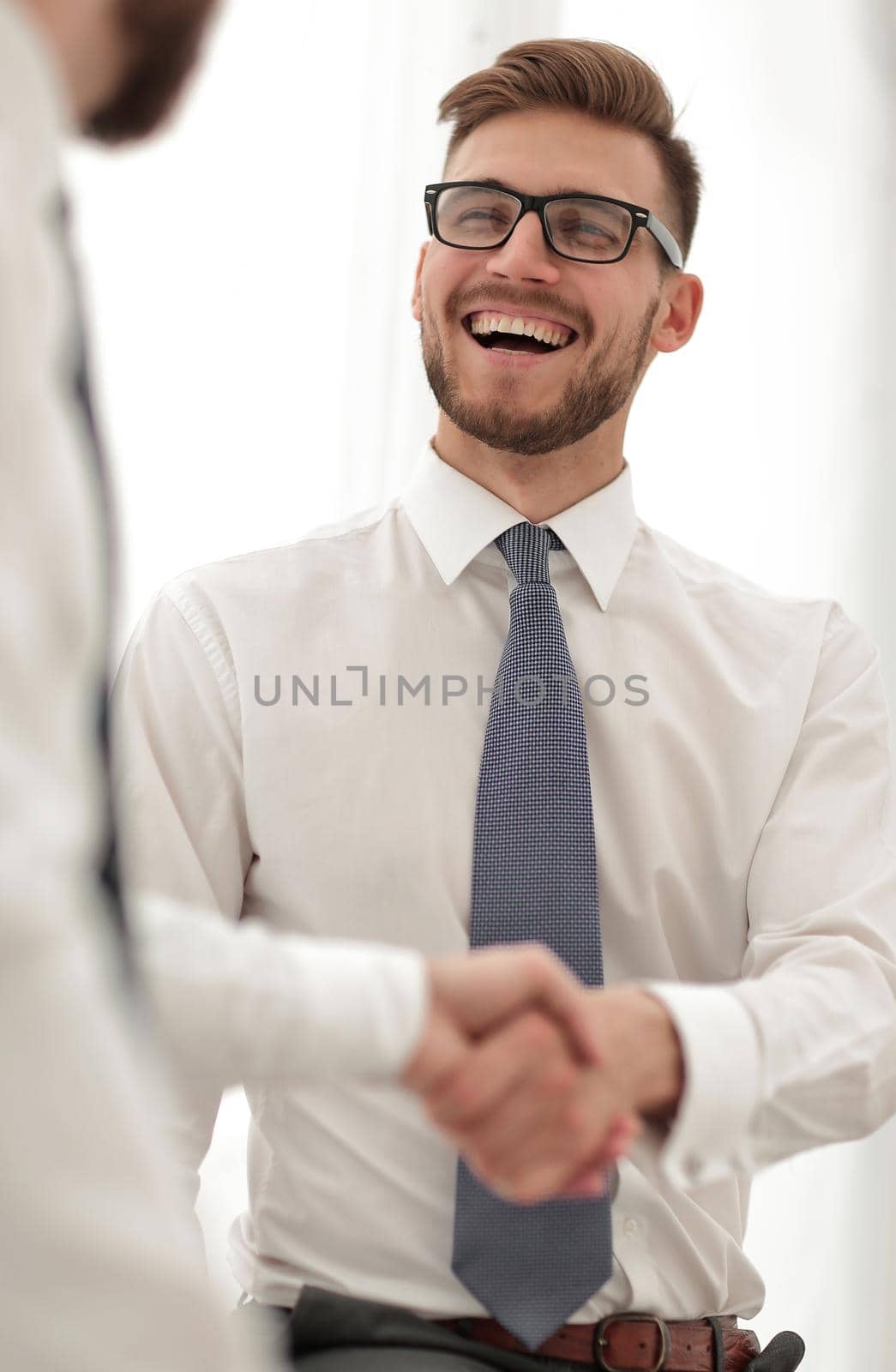 close up.business handshake of business people on a light background by asdf