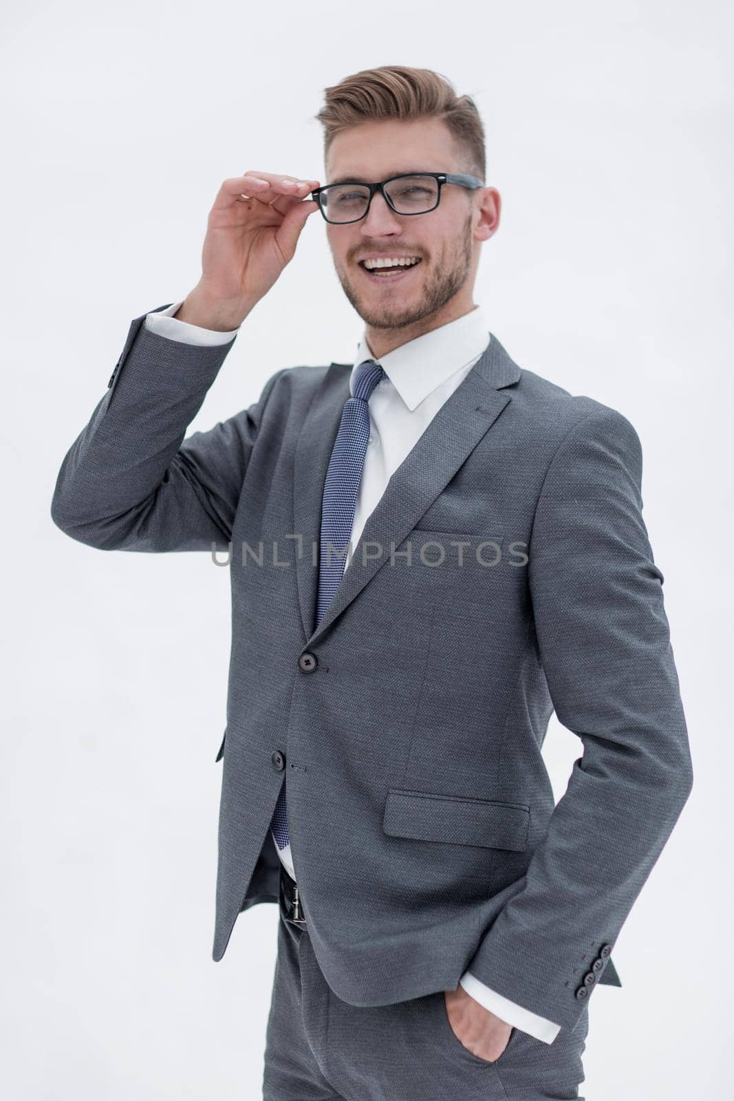 smiling businessman adjusting his glasses.isolated on white background