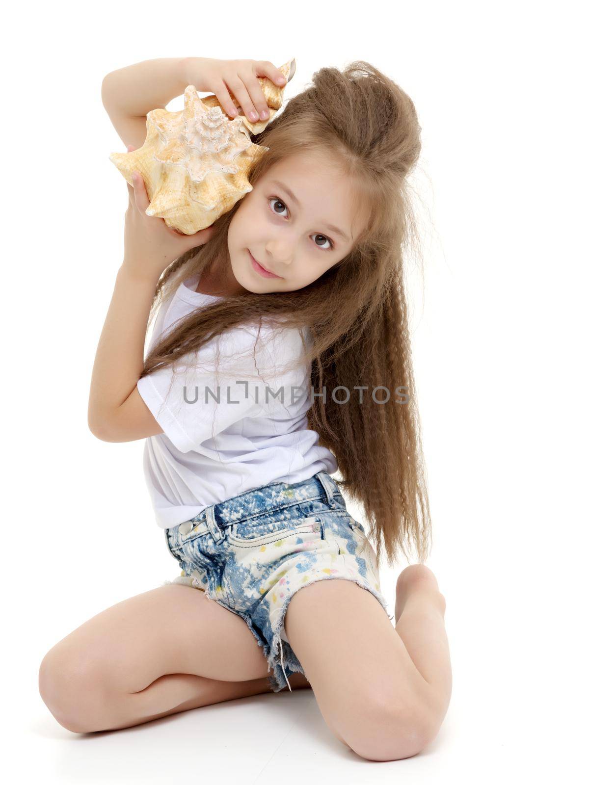 A little girl with a sea shell. The concept of a family vacation at sea, ecology. Isolated on white background.