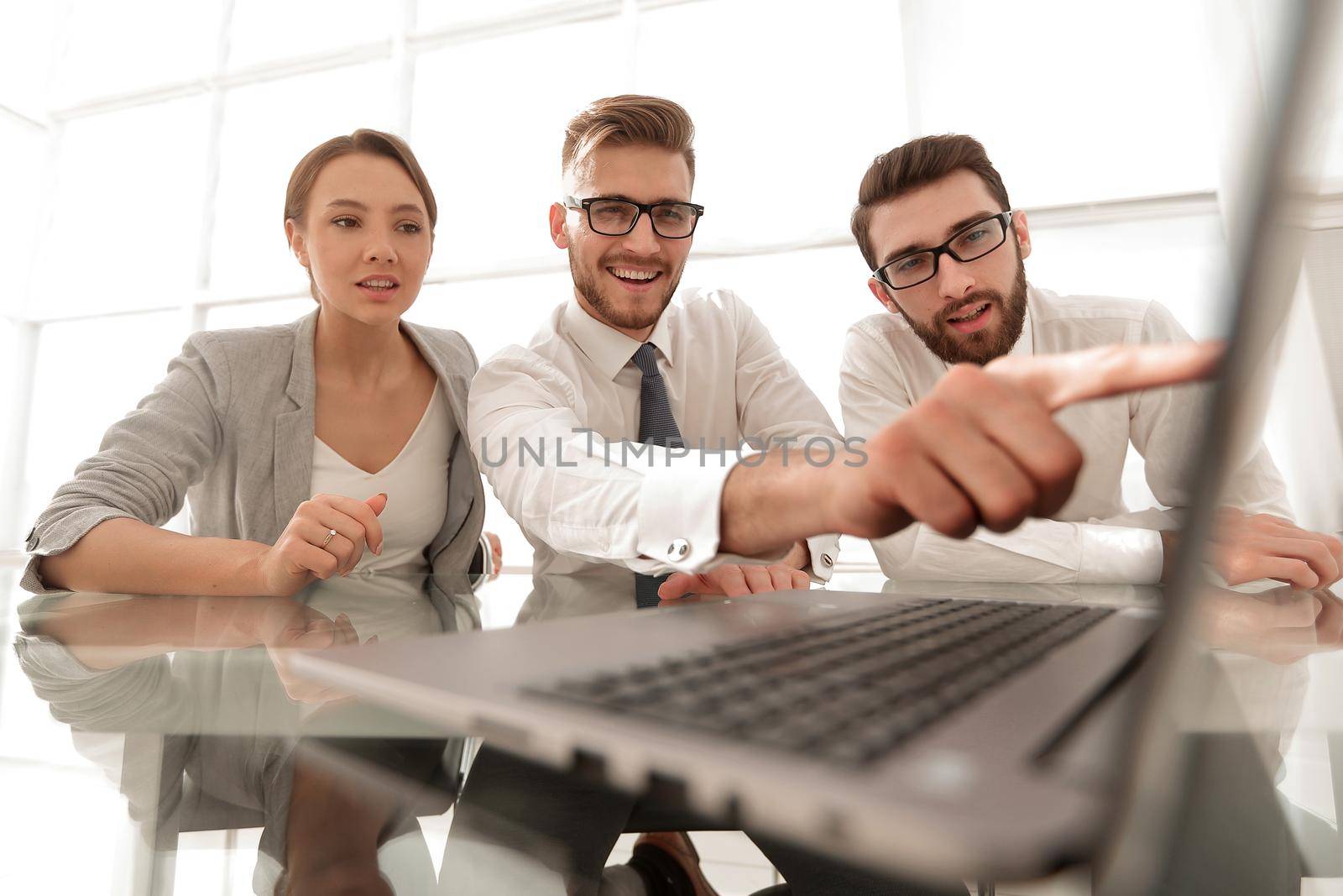 close up.smiling businessman pointing at laptop screen.business and technology