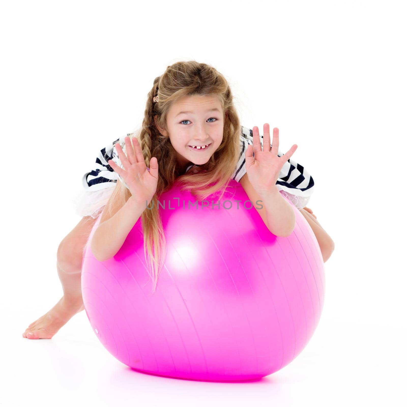 A good girl is playing with a big inflatable ball. The concept of a happy childhood, recreation in nature, exercise. Isolated on white background.