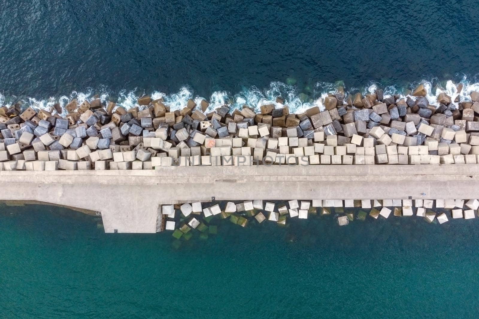 Aerial Drone Flying, Breakwater Of Stone In The Sea. by HERRAEZ