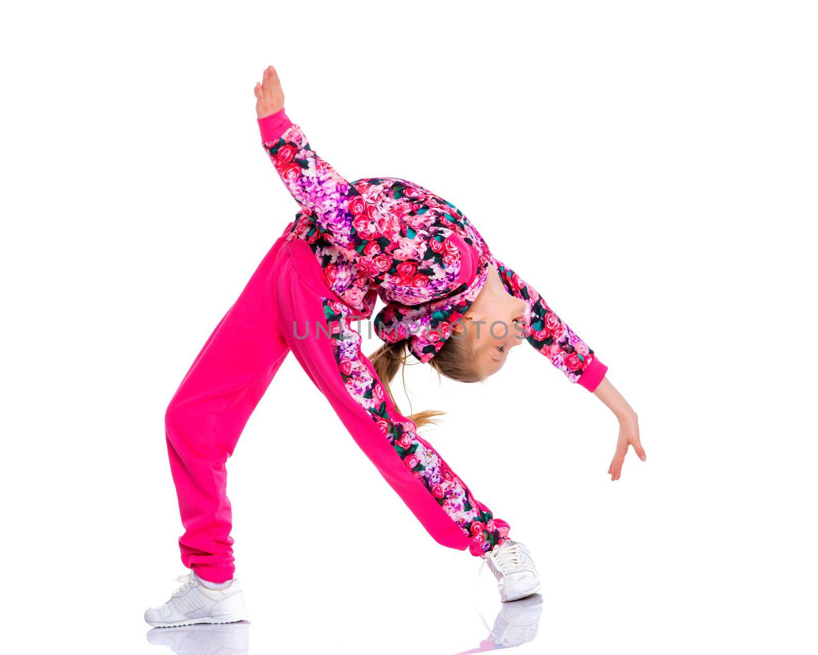 A girl gymnast performs an acrobatic element. The concept of childhood, sport, healthy lifestyle. Isolated on white background.