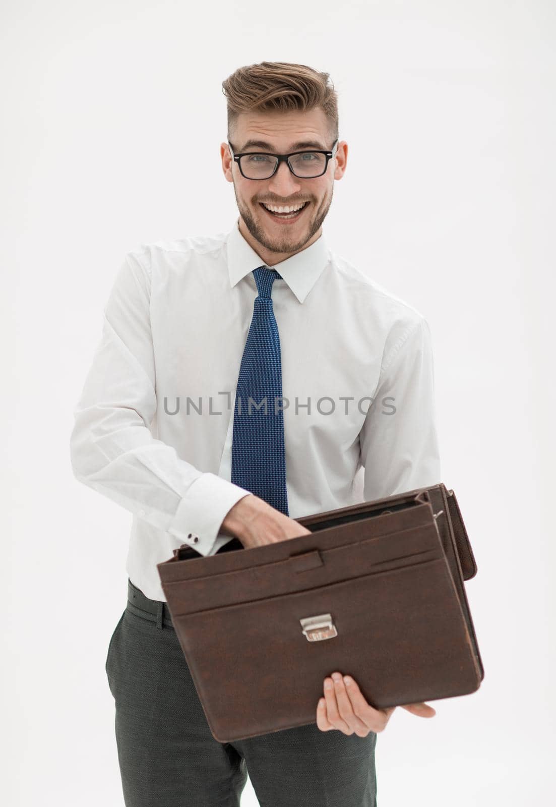 close up.smiling businessman pulls documents from the leather briefcase.isolated on white