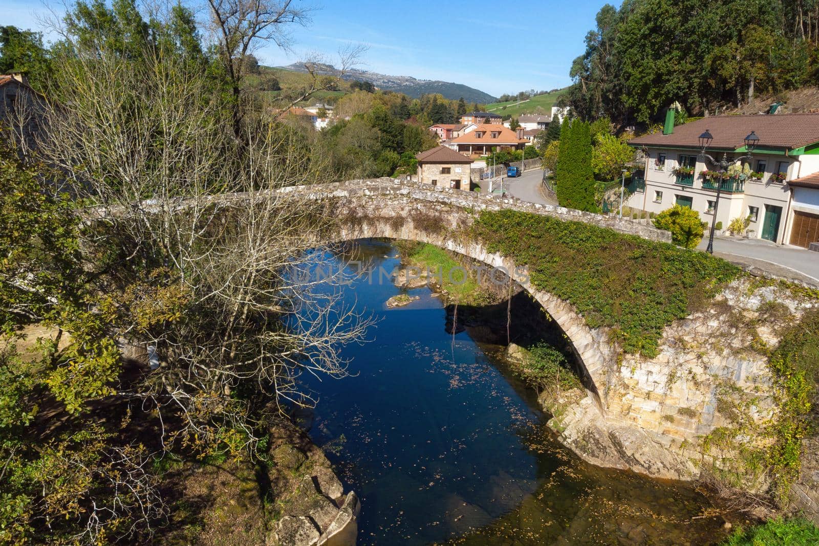 Aerial view of a scenic medieval bridge in Lierganes, Cantabria, Spain. by HERRAEZ