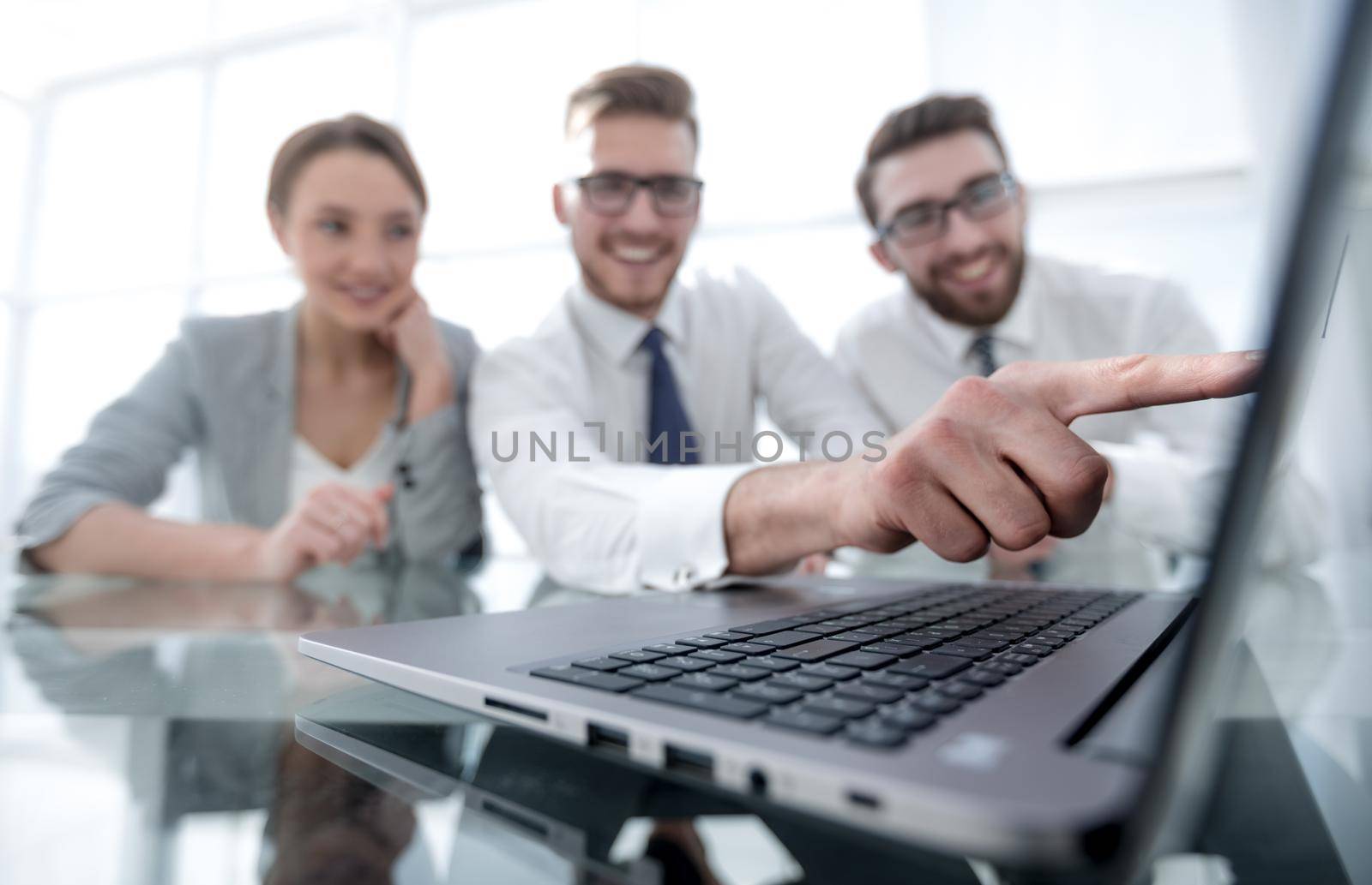 close up.smiling businessman pointing at laptop screen. by asdf