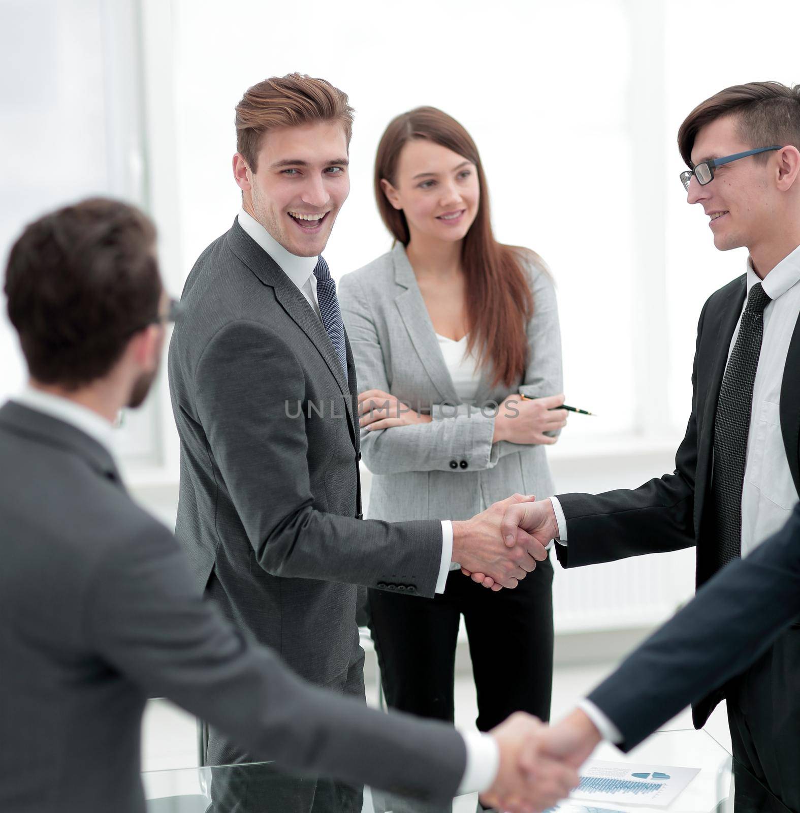 handshake of business people standing in office by asdf