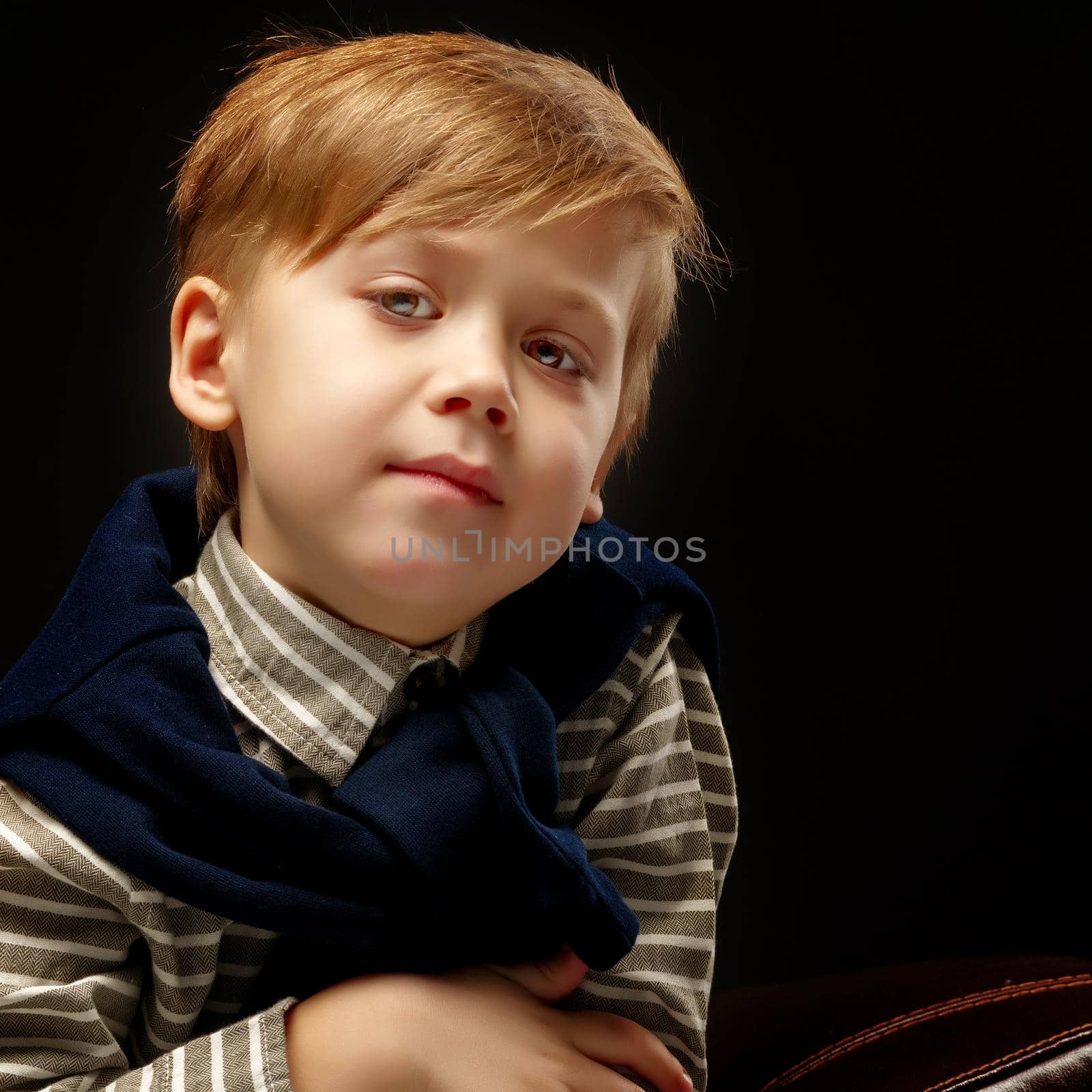Beautiful little boy on a black background, close-up. by kolesnikov_studio
