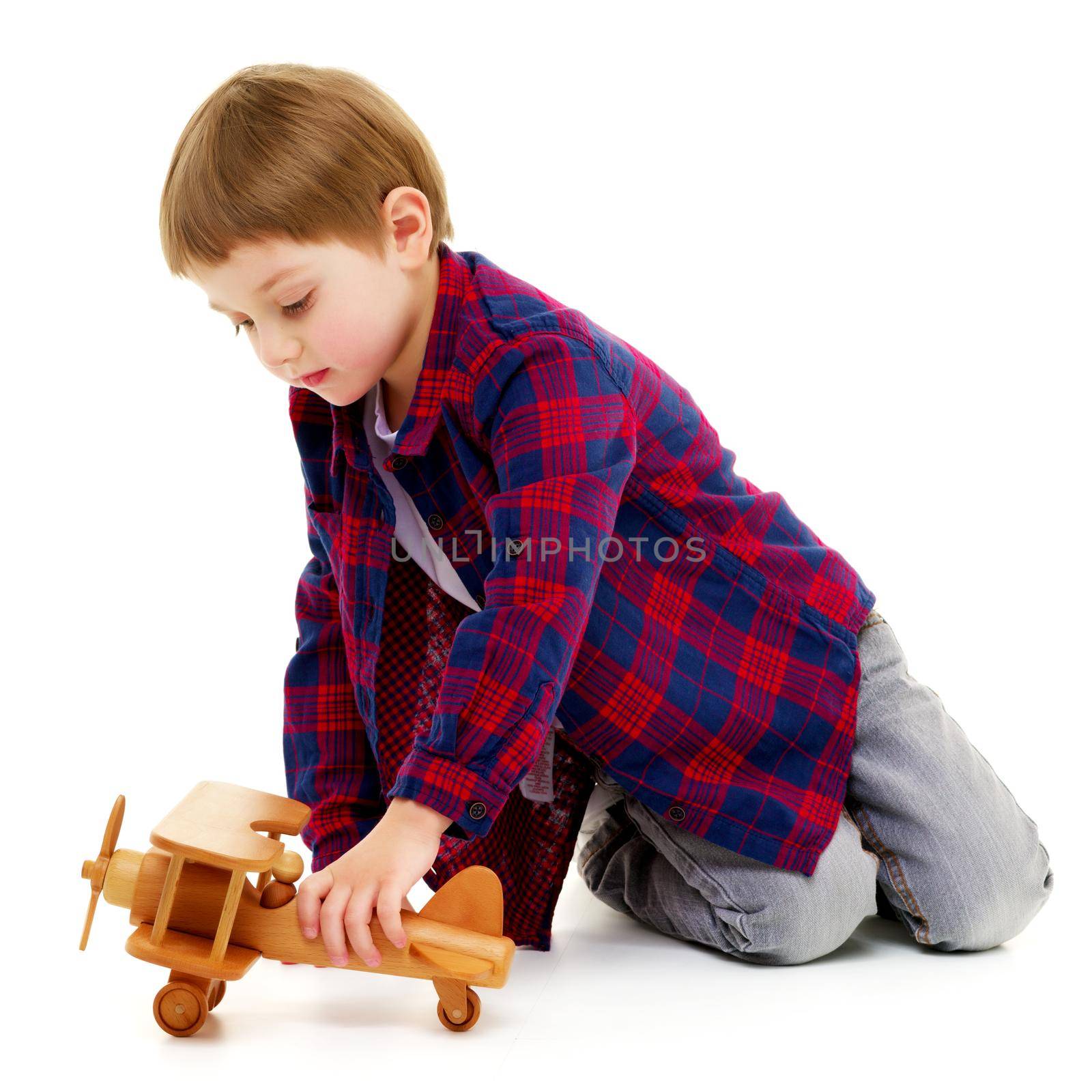 Little boy playing with wooden plane by kolesnikov_studio