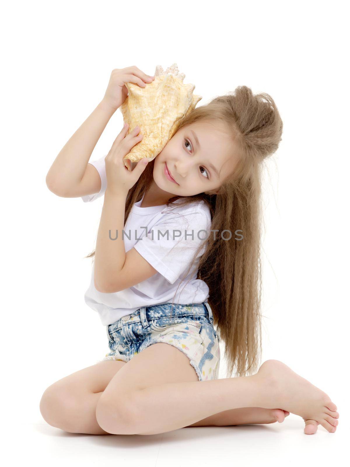 A little girl with a sea shell. The concept of a family vacation at sea, ecology. Isolated on white background.