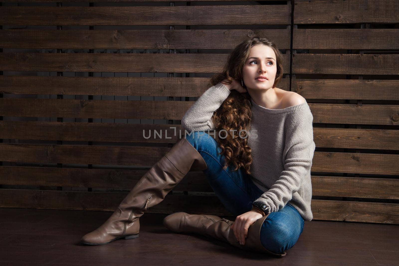 young woman in cowboy style clothes on wooden background