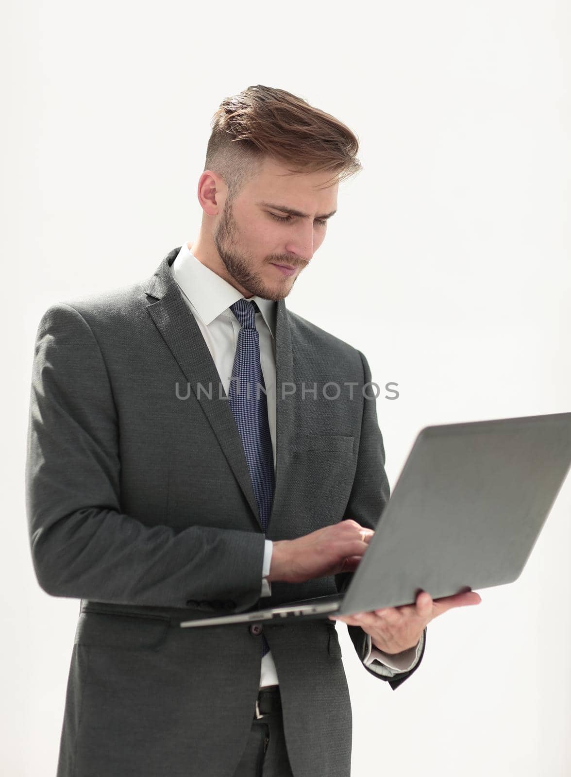 close up.businessman examines a new laptop.isolated on white