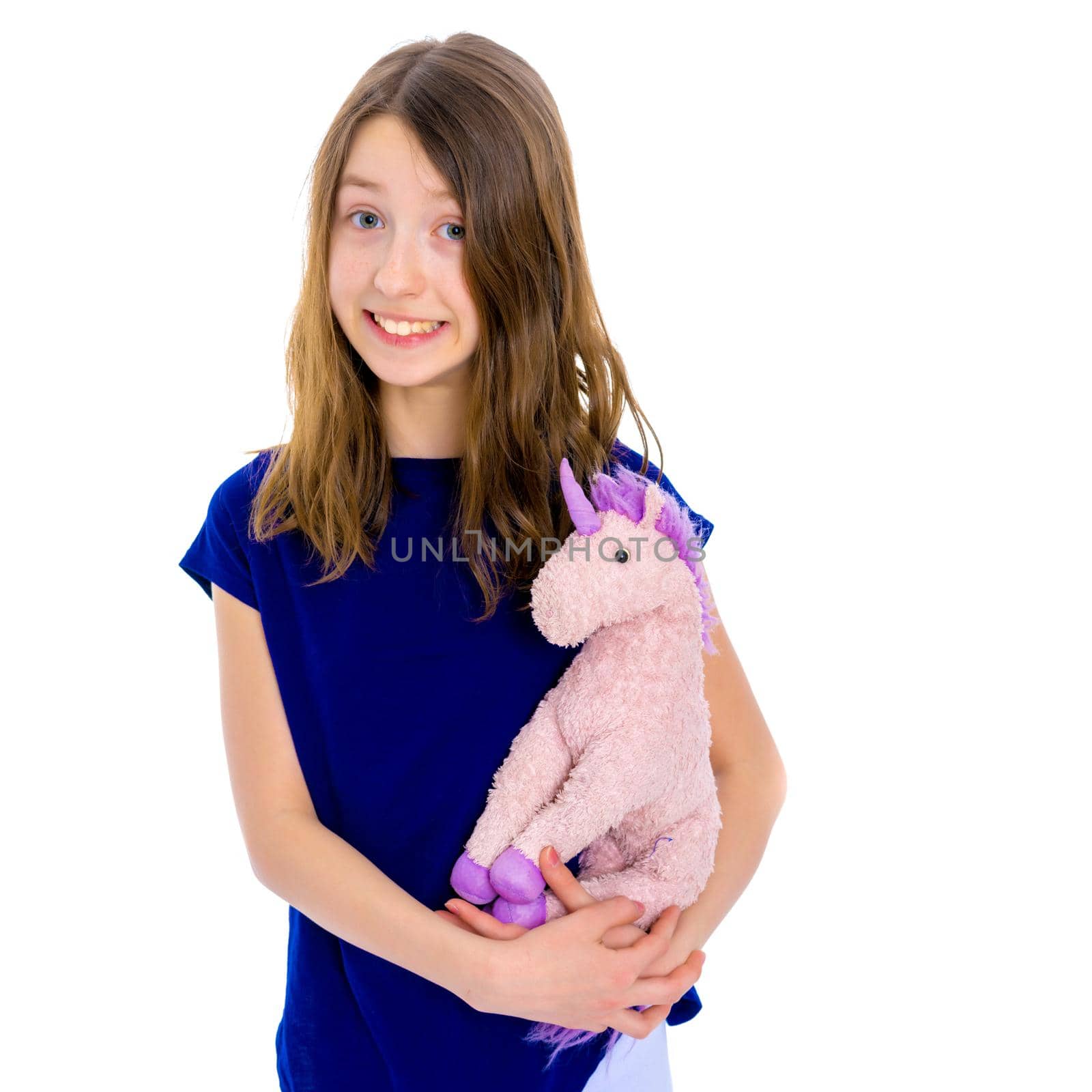 A cute little caucasian girl with a toy in her hands. The concept of a happy childhood, family. Isolated on white background.