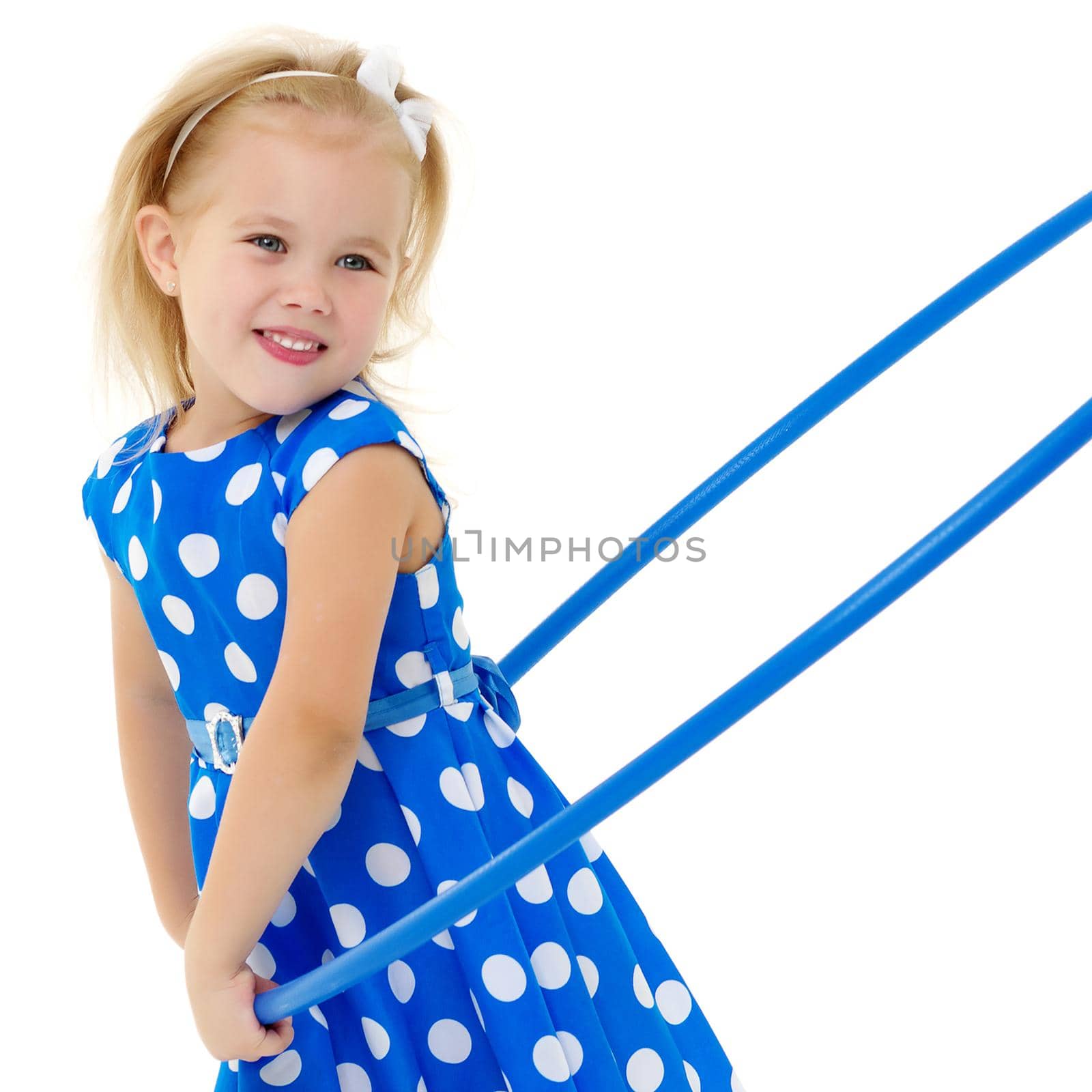 Happy little girl playing with a hoop. The concept of a happy childhood. Isolated on white background.