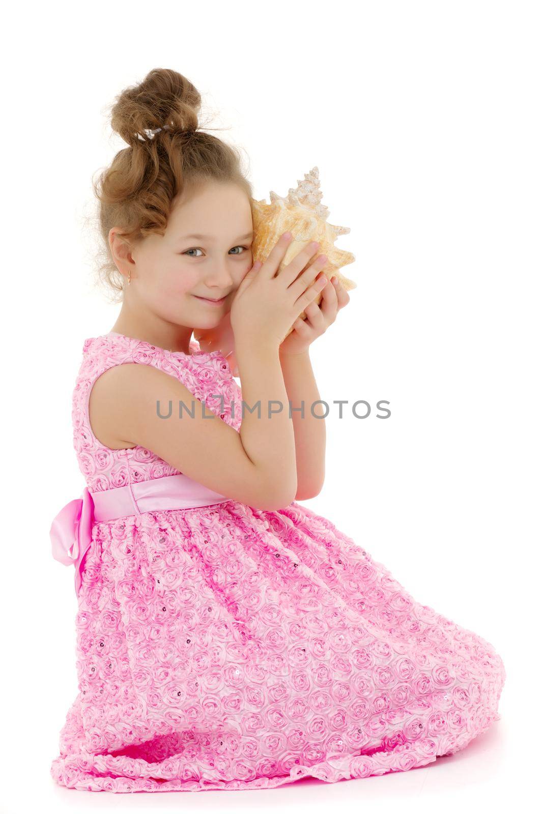 A little girl with a sea shell. The concept of a family vacation at sea, ecology. Isolated on white background.