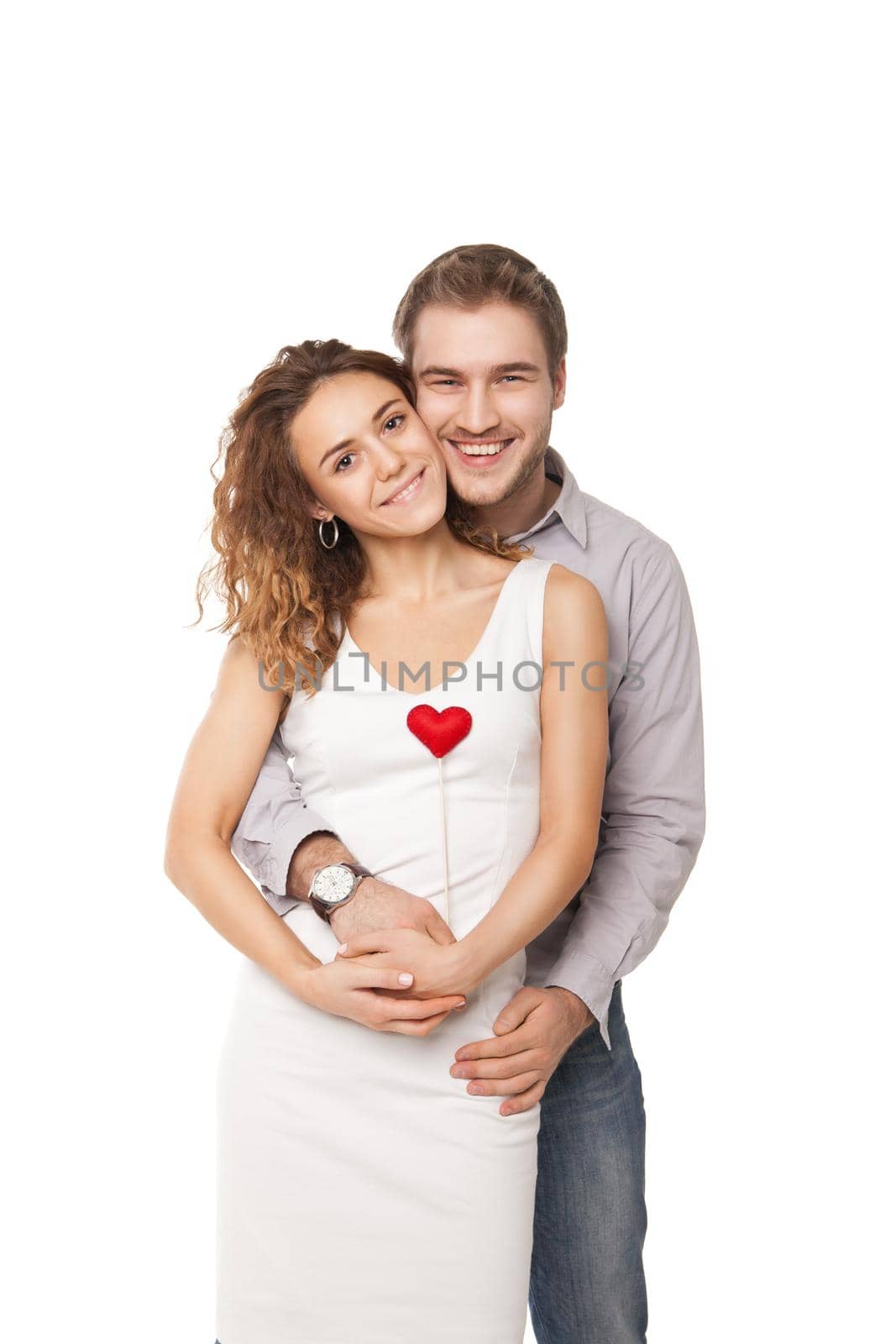 Portrait of joyful couple holding red hearts and laughing isolated on white