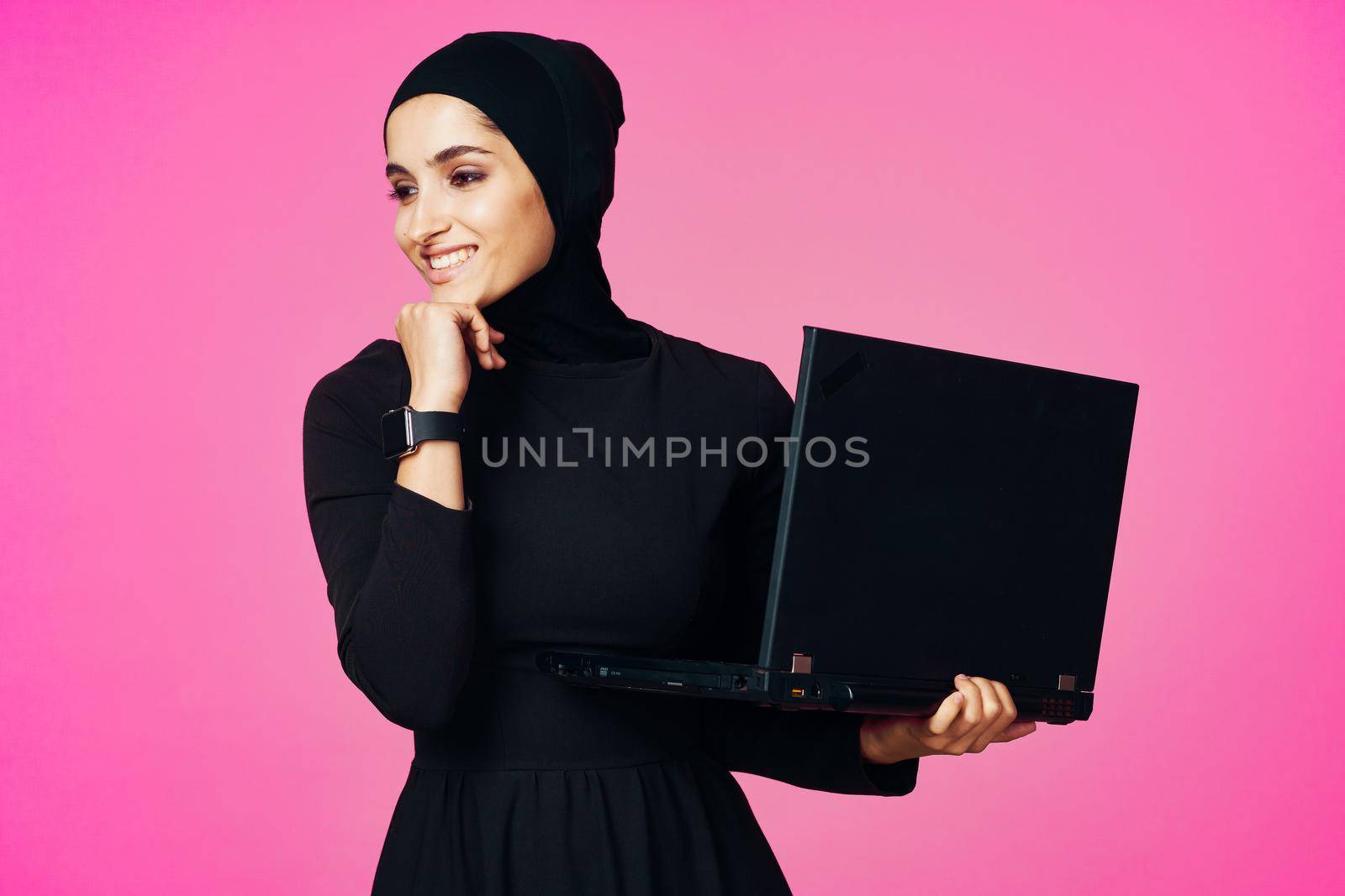 cheerful muslim woman with laptop education student internet technology. High quality photo