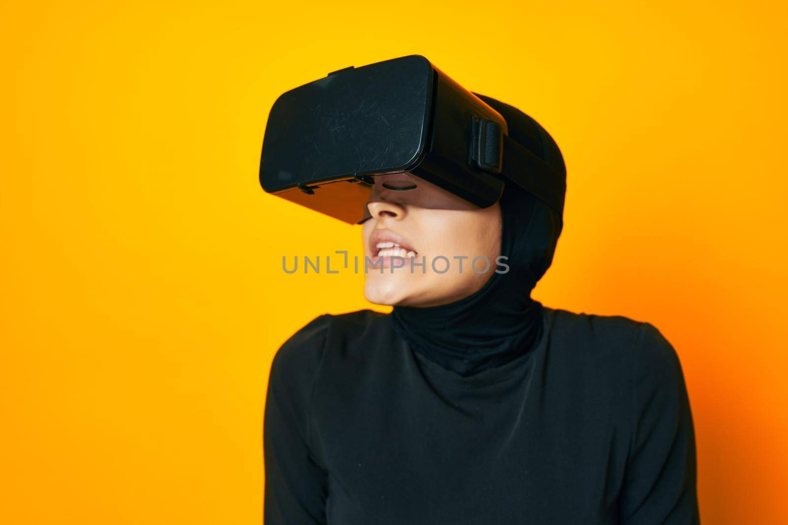 pretty woman in black hijab VR glasses emotions isolated background. High quality photo