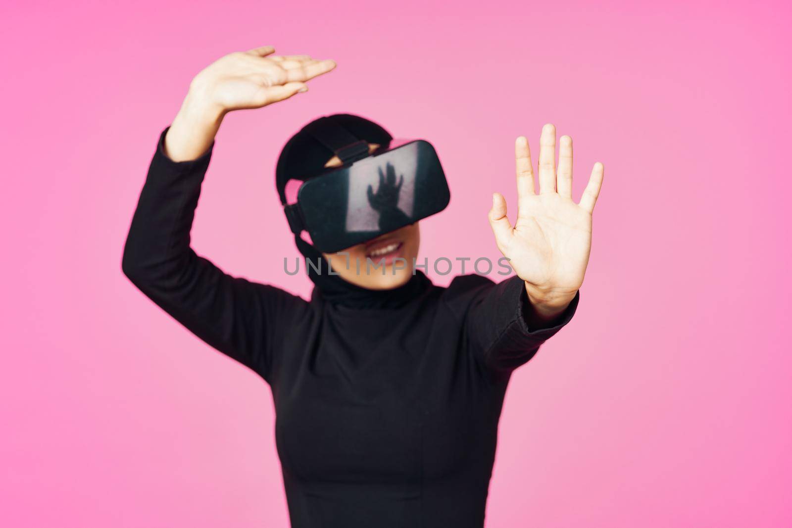 muslim woman wearing virtual reality glasses entertainment technology device. High quality photo